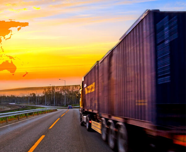Container truck on the highway at sunset